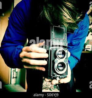Using a old fashioned Rolleiflex film camera Stock Photo