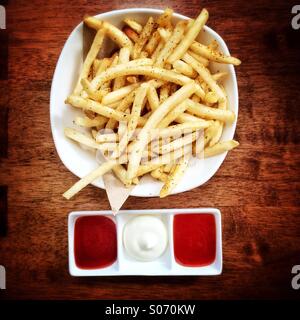 Bowl of chips with dipping sauces Stock Photo