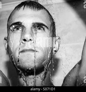 Guy in shower with wet face Stock Photo