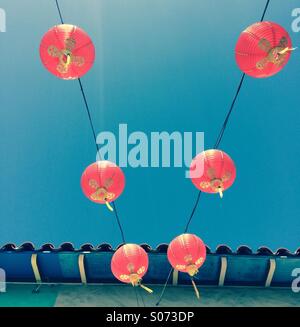 Red Chinese lanterns against blue sky, perspective shot Stock Photo