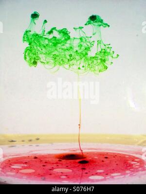 Oil mixing with water and forming a tree shape Stock Photo