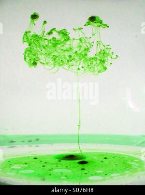 Oil mixing with water forming a tree shape Stock Photo