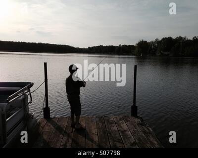 Silhouette boy fishing from dock hi-res stock photography and images - Alamy