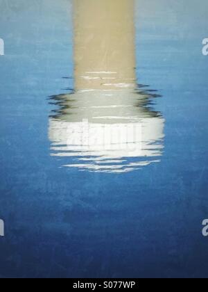 A rippling reflection of a water tower. Stock Photo