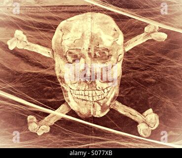 The skull and crossbones on the flag of a pirate ship. Stock Photo