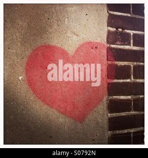 A red heart painted on a wall as grafity Stock Photo