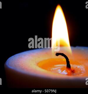 Lit candle Stock Photo