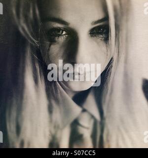 Teenage girl in school uniform, crying Stock Photo