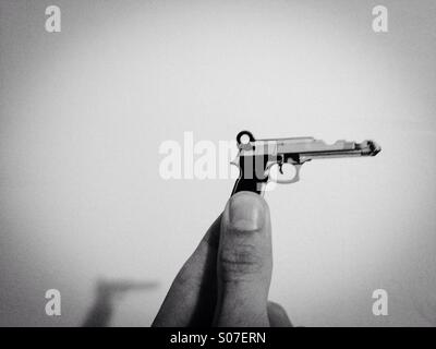 A house key in the shape of a gun Stock Photo