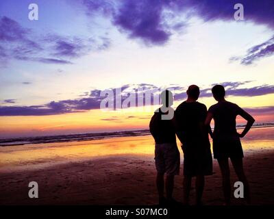 Three friends on the beach, Pacific Ocean, Costa Rica Stock Photo