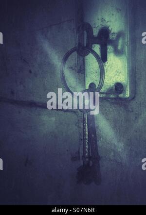 Rusty keys in old door lock. Stock Photo