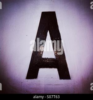 Letter A in black color sticked to the wall Stock Photo