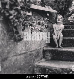 Young girl sitting on stairs Stock Photo