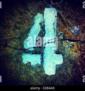 Rough number 4 painted in white color Stock Photo