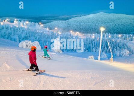 Kids skiing at Ruka ski resort, Kuusamo, Finland. MR available Stock Photo