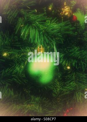 Green bauble on a Christmas tree Stock Photo