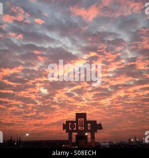 Sunrise over the cross of the basilica of Guadalupe during the pilgrimage to the Basilica of Our Lady of Guadalupe, Tepeyac Hill, Mexico City, Mexico Stock Photo