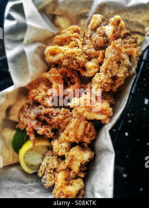 Deep fried calamari batter coated with salt and lemon slice Stock Photo