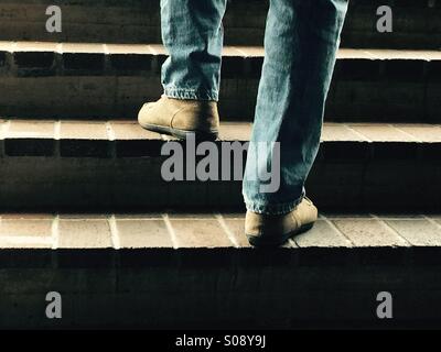Man going up stairs Stock Photo