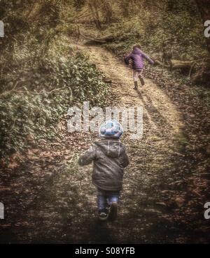 Children playing in the woods Stock Photo