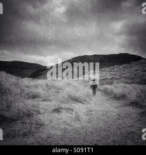 Person walking on dunes Stock Photo