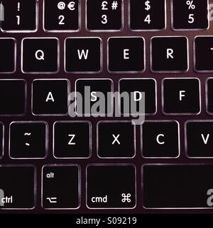 Laptop keyboard lit up in the dark Stock Photo