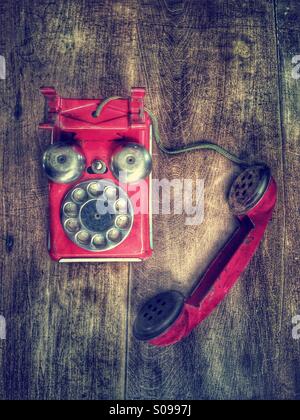Red vintage toy telephone. Stock Photo