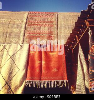 Carpets on sale in the souk of Marrakech medina, Morocco. Stock Photo