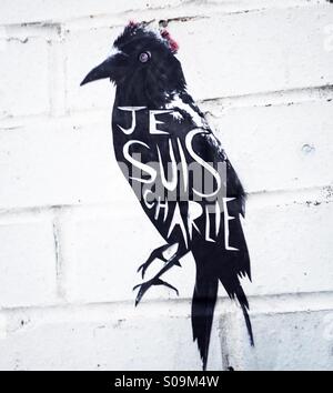 A street art Raven pasteup by artist Alex Ekins with Je Suis Charlie written on it in Sheffield England United Kingdom UK Stock Photo