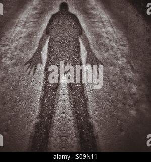 Scary shadow with huge hands Stock Photo