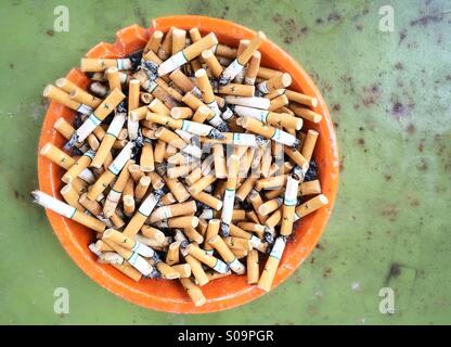 Ash tray full of cigarettes. Stock Photo