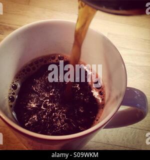 Black coffee being poured Stock Photo