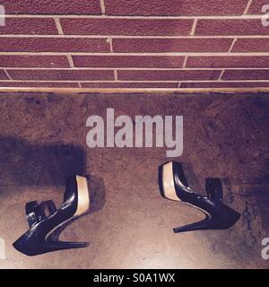 Mary Jane high heels next to an exposed brick wall Stock Photo