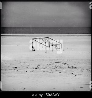 Football goal on an empty winter beach Stock Photo