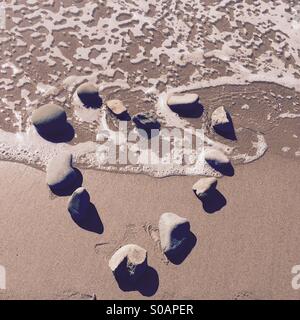 Rocks in the shape of a heart at the shoreline. Ventura, California USA. Stock Photo