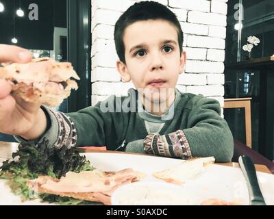 Child eat in fast food restaurant Stock Photo