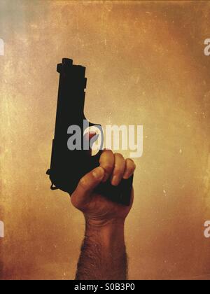 Criminal holding a gun Stock Photo