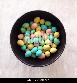 Bowl of small sugar-covered chocolate Easter eggs. Stock Photo