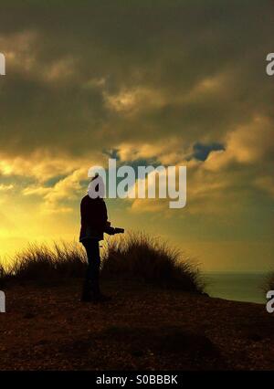 Cliff top silhouette Stock Photo