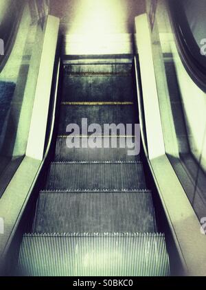 Looking down escalator in shop England UK Stock Photo