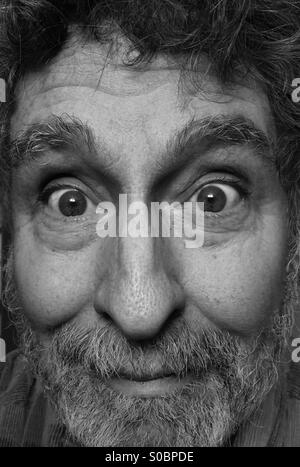 White man, age 64, with beard and expression of humor and tenderness, extreme close-up, Seattle, USA Stock Photo