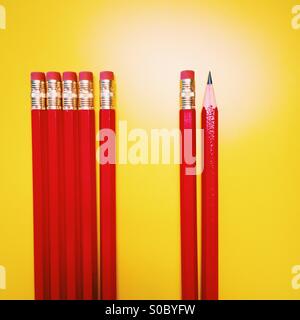 A single sharpened pencil pictured with other pencils. Stock Photo