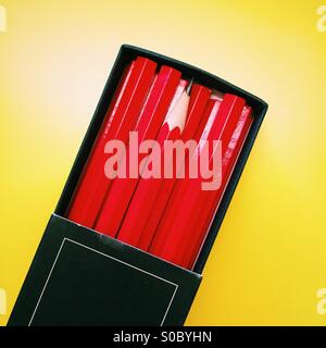 A single sharpened pencil in a box of unsharpened pencils. Stock Photo