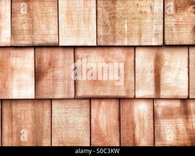 New, pre-weathered, sustainably sourced, overlapped cedar shingles as used on a roof or as building cladding. Stock Photo