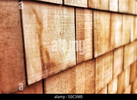 Sustainably sourced, pre-weathered, Western Red Cedar shingles shot with a receding DoF. Used as roofing material or building cladding. Stock Photo