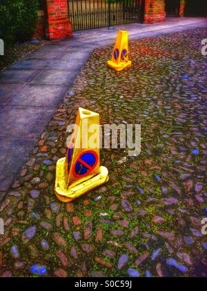 Police no waiting cones on cobbled street England UK Stock Photo