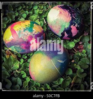 Three colorful easter eggs on grass background Stock Photo