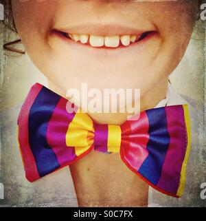 Smiling girl with colourful bow tie Stock Photo