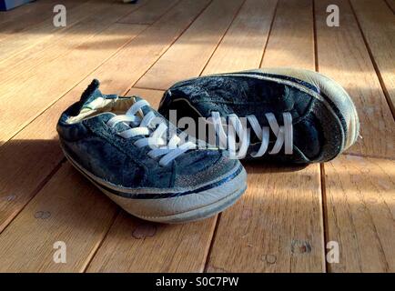 Worn out kids shoes Stock Photo - Alamy