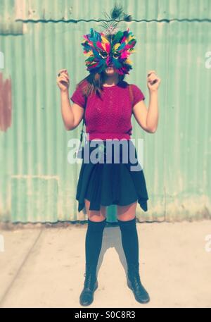 Woman wearing colorful feather mask in New Orleans, Louisiana. Stock Photo